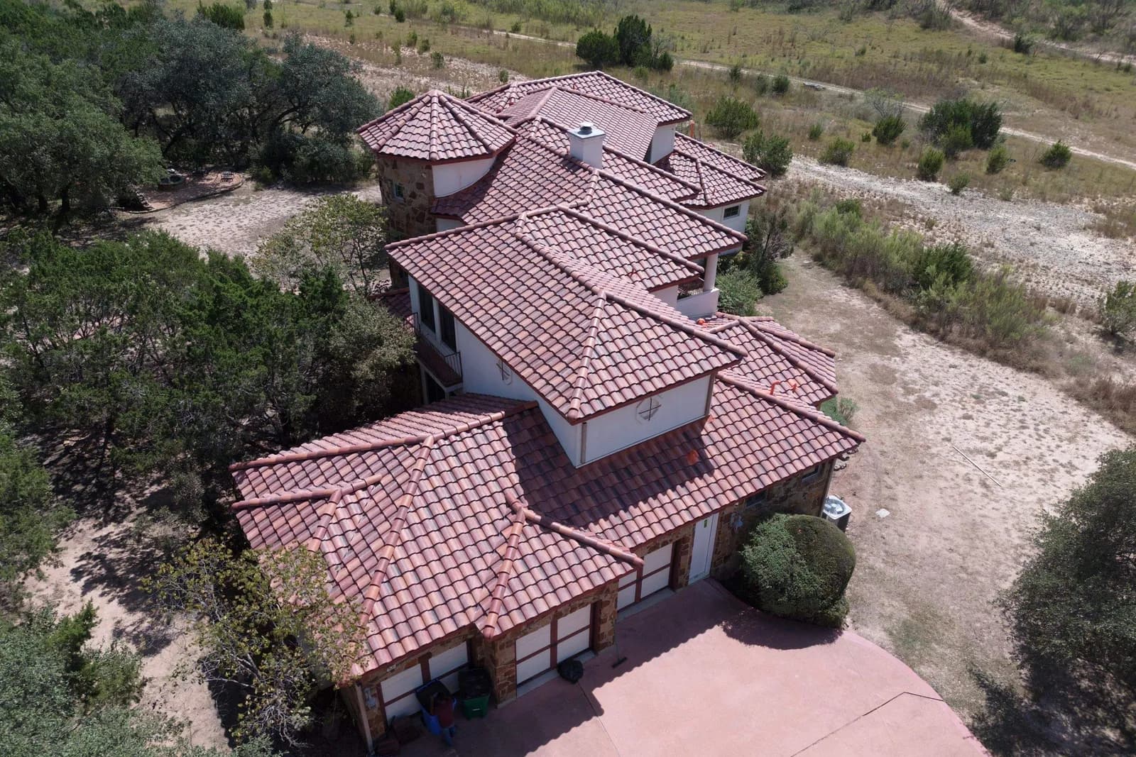 Aerial view of a finished concrete tile roof on an Austin home