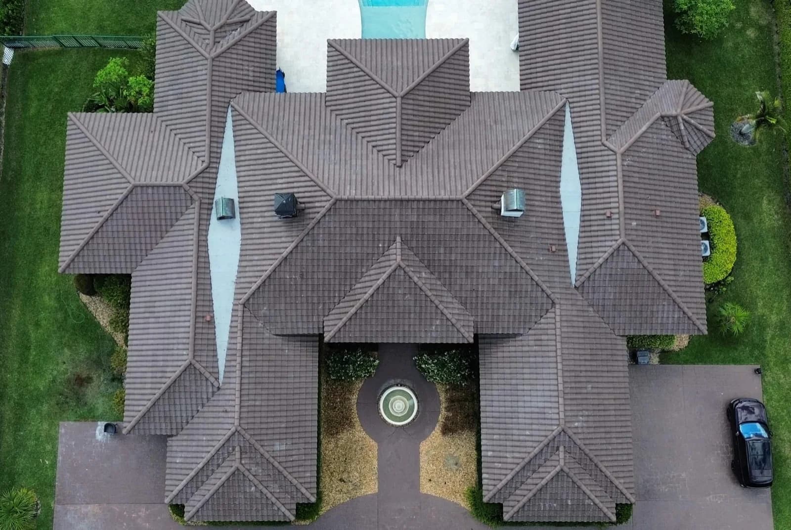 Aging residential roof showing visible wear signs including curling shingles and granule loss