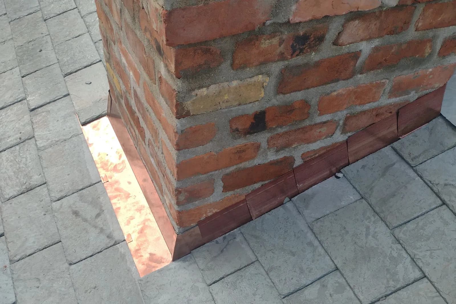 Close-up of a slate roof with copper valley flashing