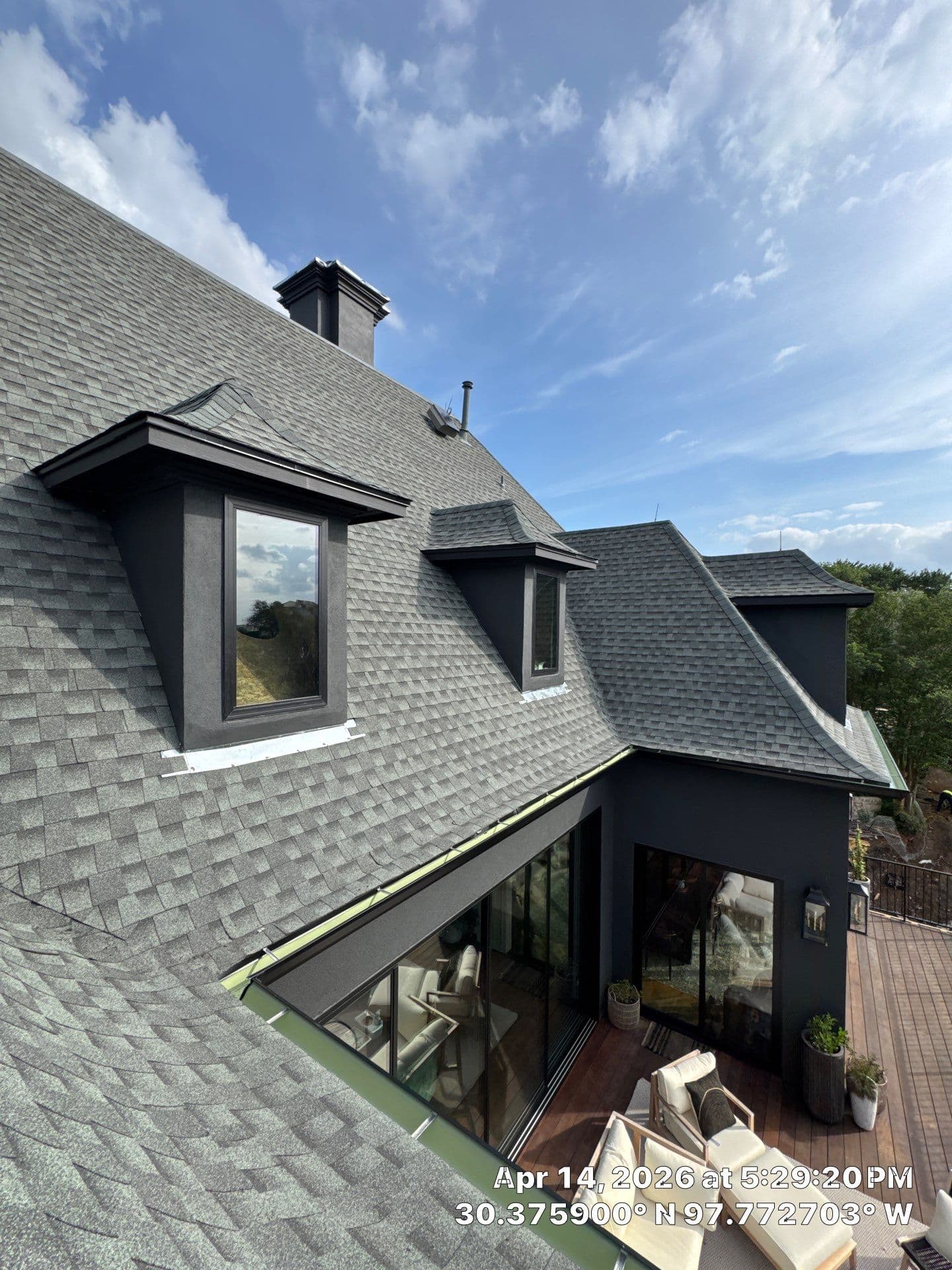 Shingle roof slopes and dormers at a roofing project in Austin
