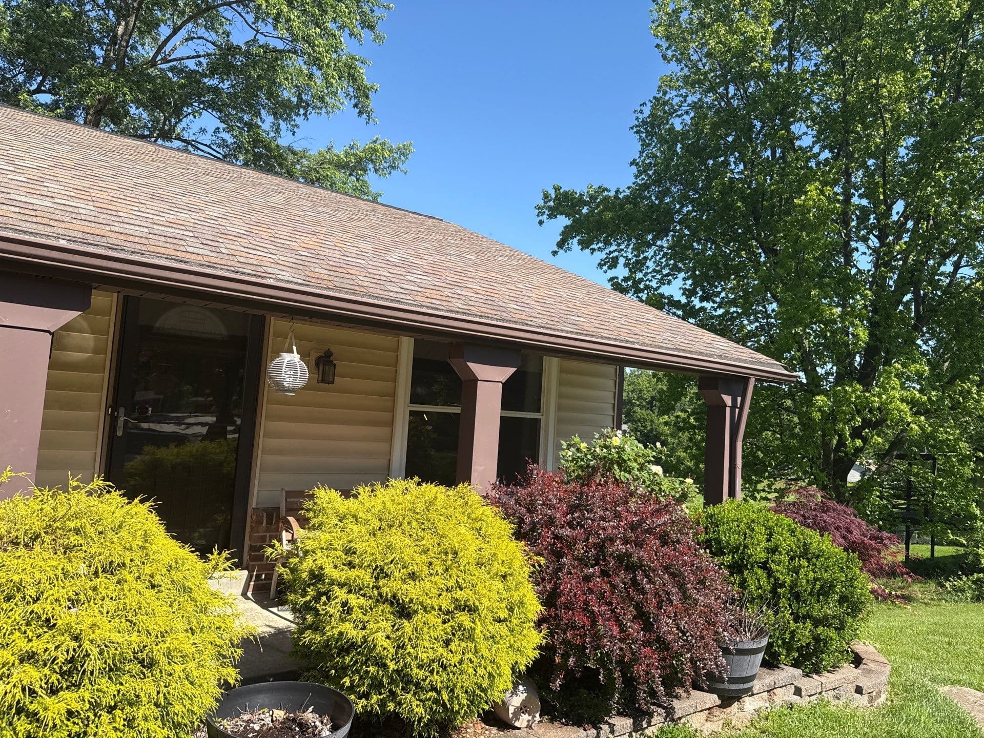 Shingle roof above a covered front porch at a Maryland Heights property