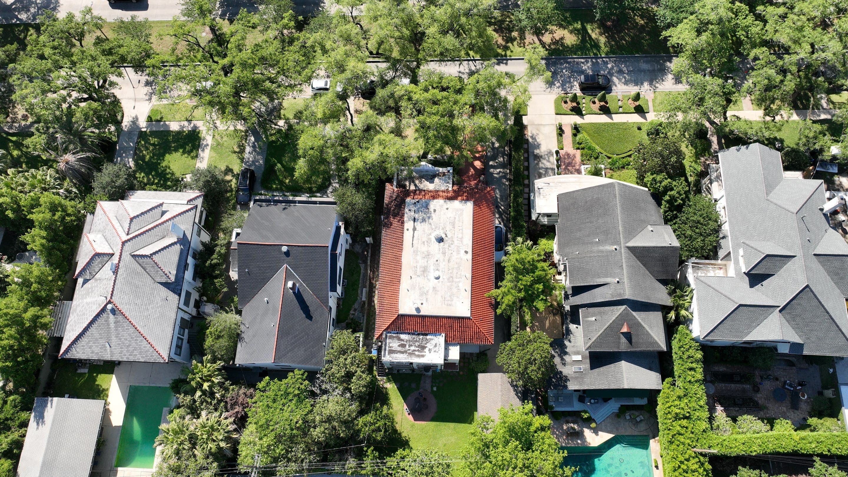 Aerial view of roof layouts, neighboring homes, and tree canopy on Audubon Boulevard in New Orleans