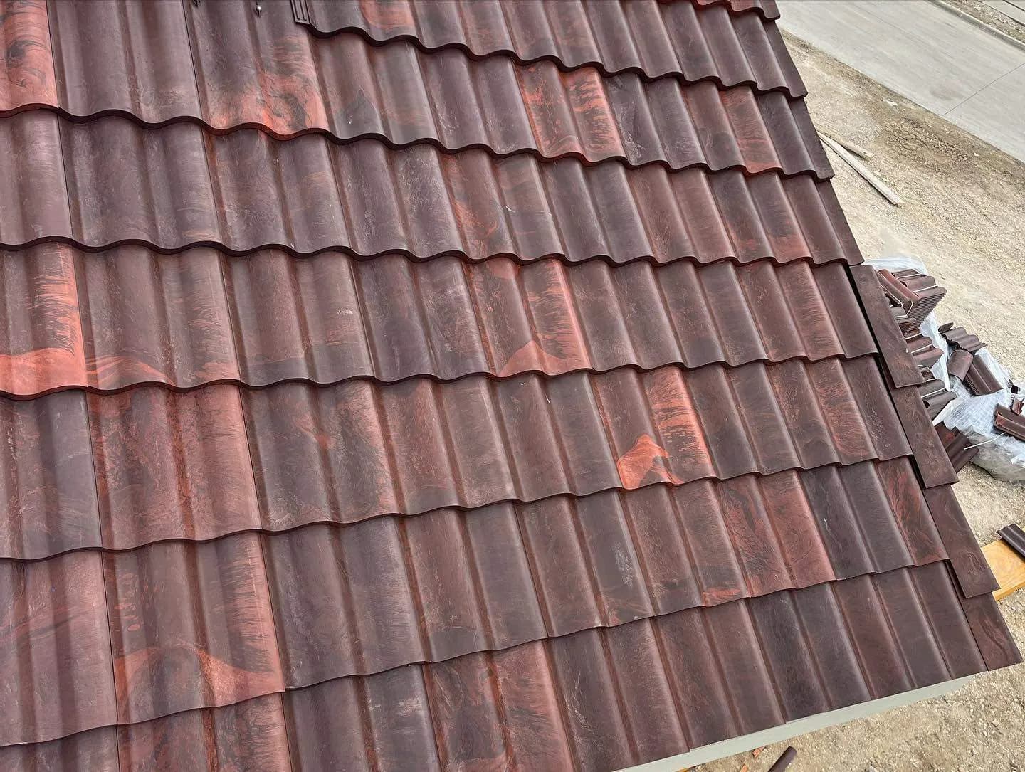 Clay barrel tiles staged in stacks during a tile roof installation