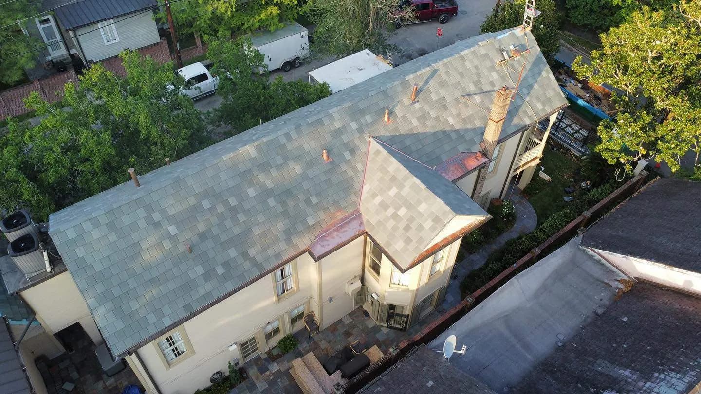 Finished estate slate roof at golden hour, aerial view