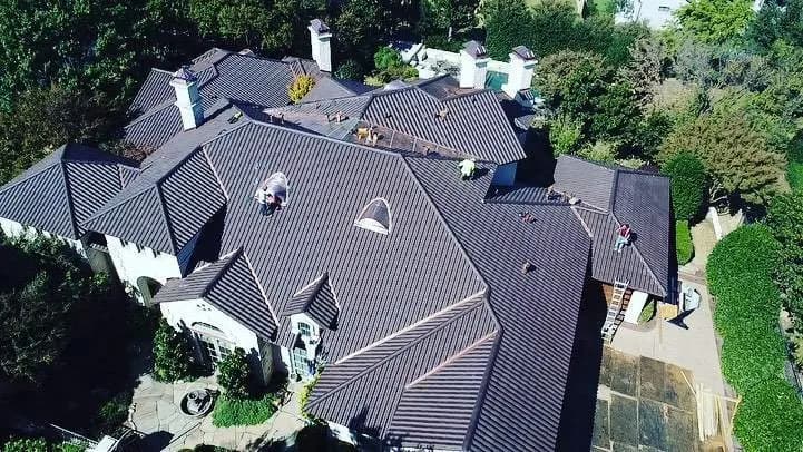 Crew installing a Ludowici clay tile roof, aerial view