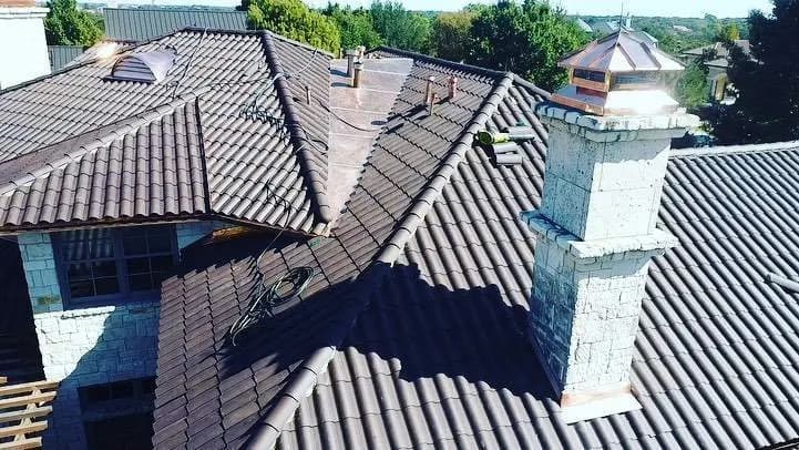 Ludowici clay tile roof with stone chimney and cupola, aerial view