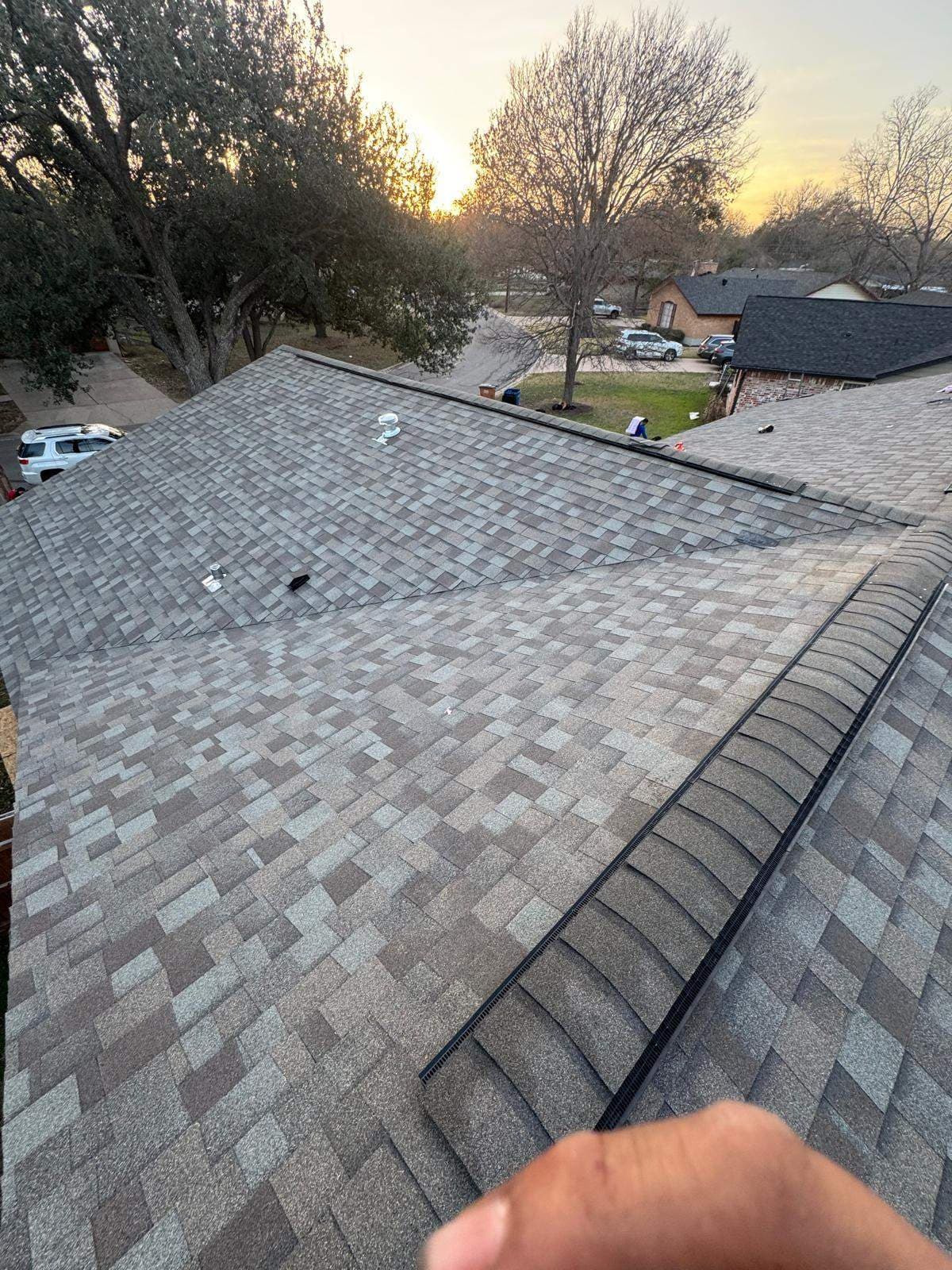 Architectural shingles, ridge vents, and roof penetrations on an Austin roof replacement