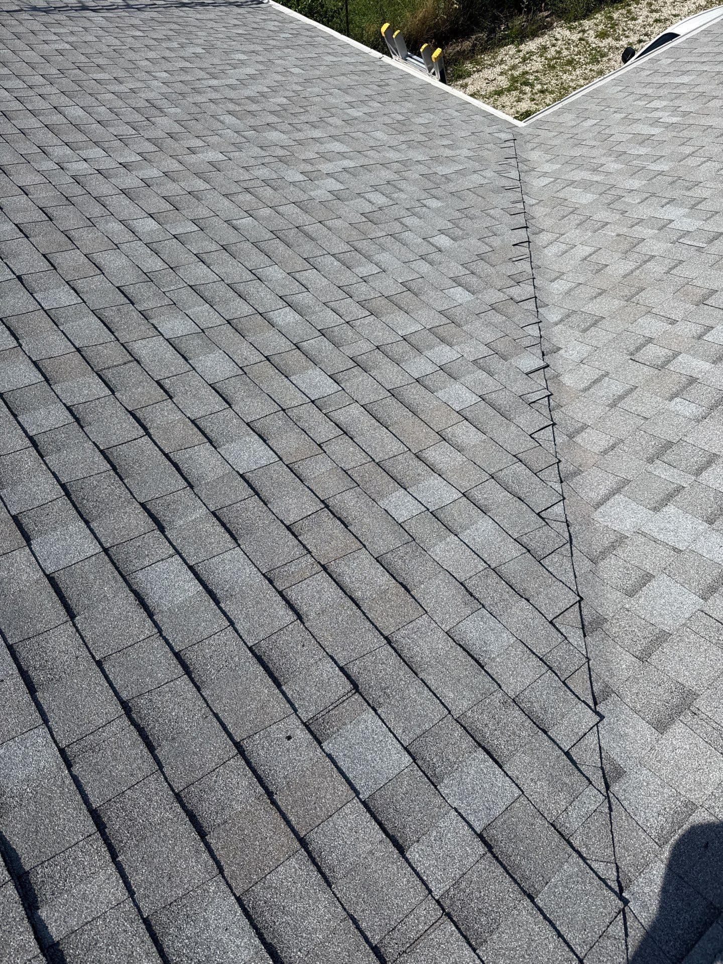Gray architectural shingles meeting at a valley on a Catawissa roof replacement