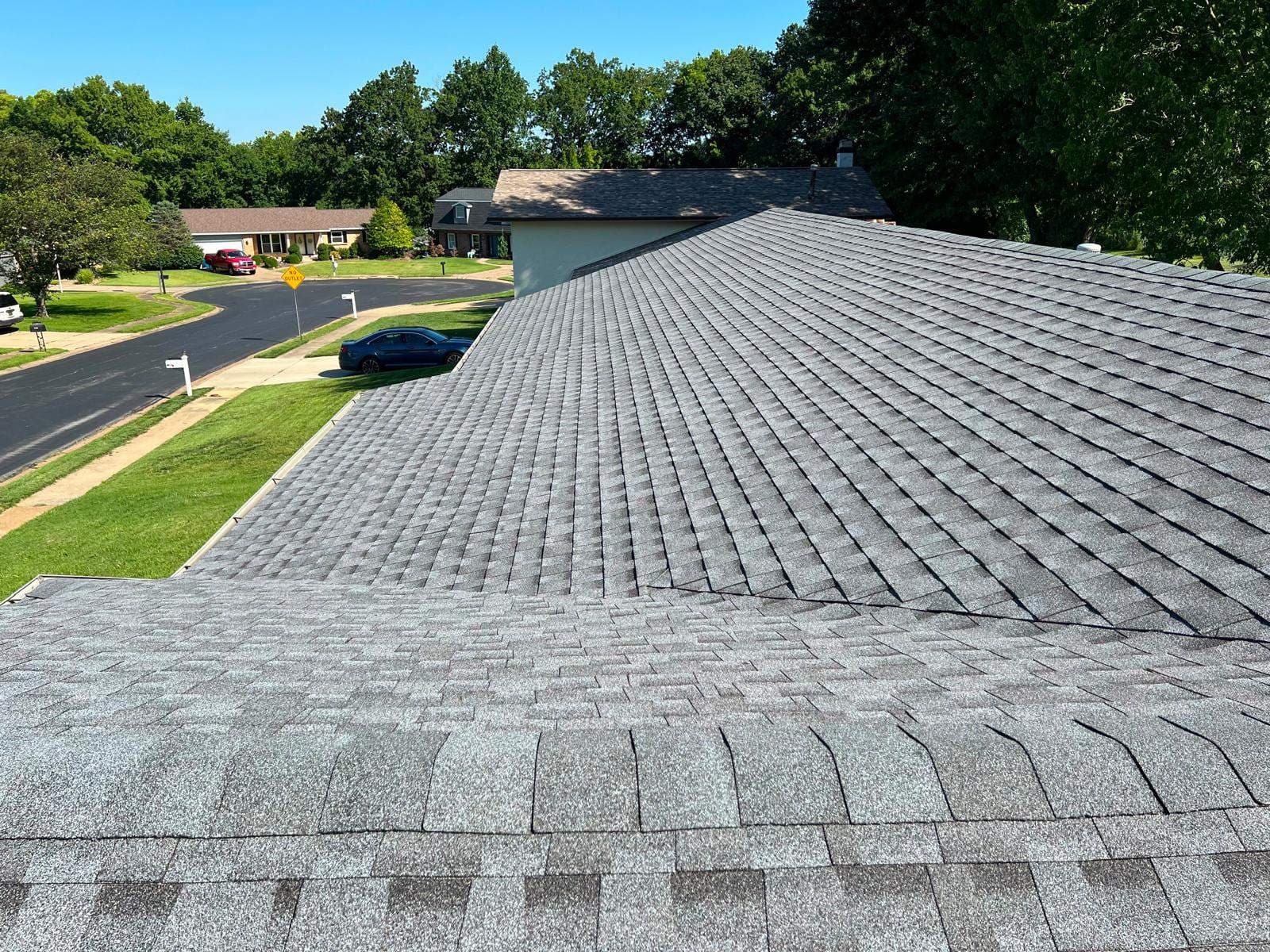 Gray shingle roof with intersecting hips and valleys on a St. Charles roofing project