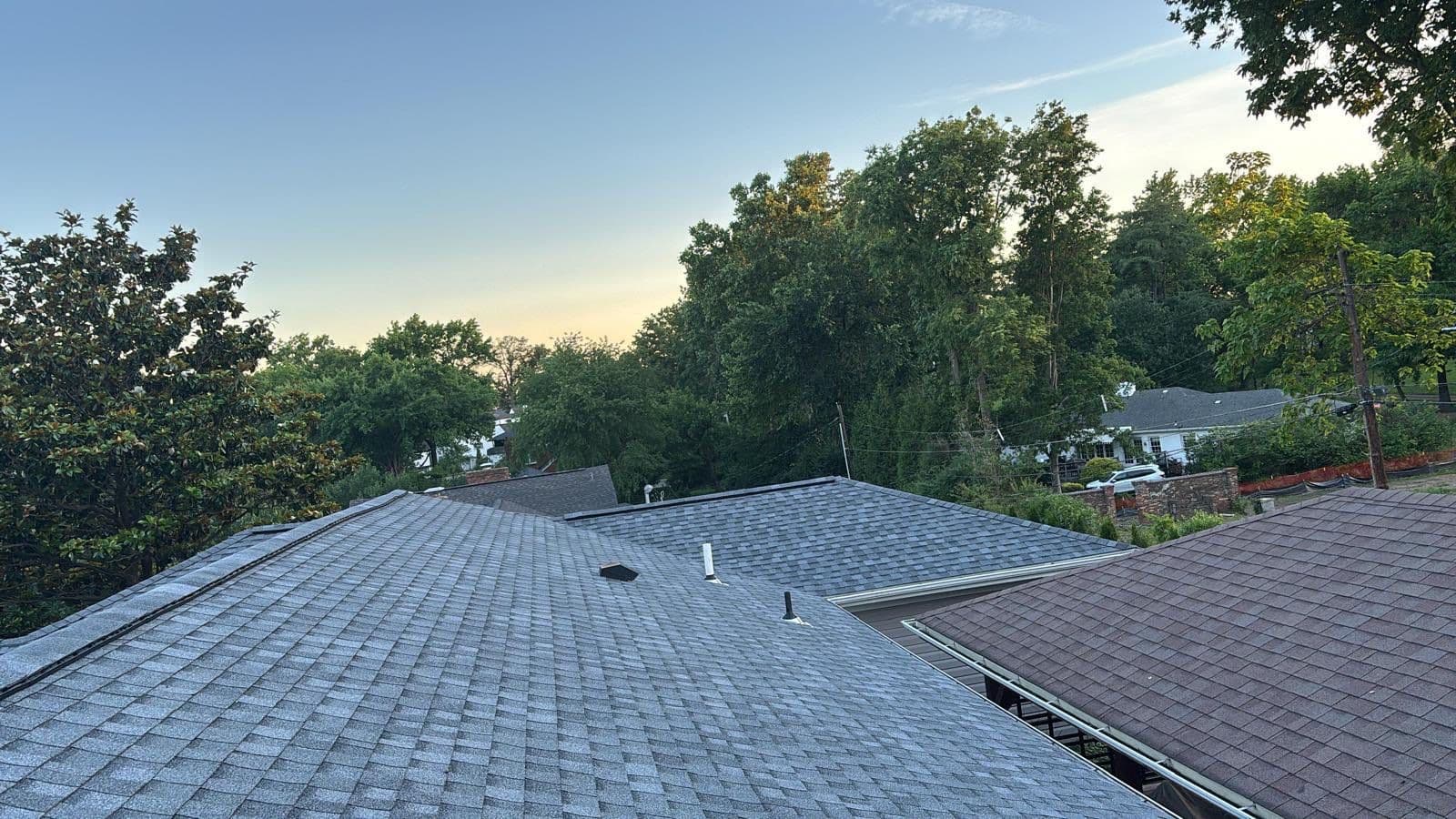 Gray shingle roof with a ridge and several penetrations on a St. Louis-area roofing project