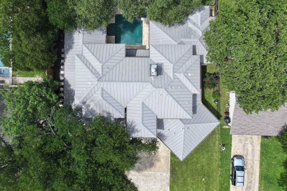 Aerial view of a standing-seam metal roof Lapeyre Roofing installed on an Austin home