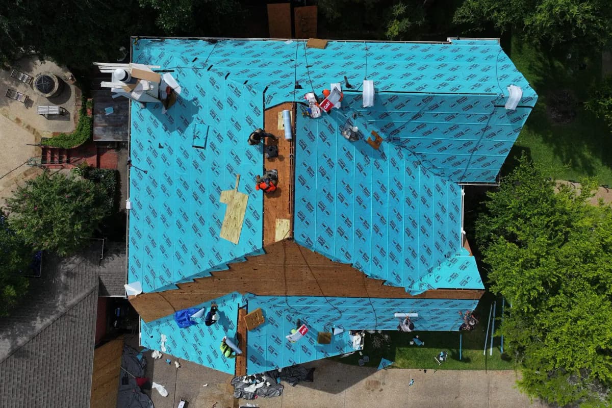 Roofer installing a residential roof in Hays County, TX