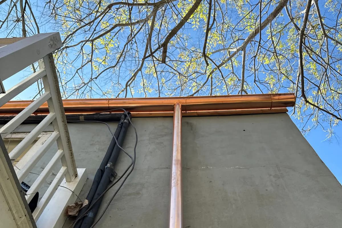 Slate roof edge with copper flashing and gutter detail
