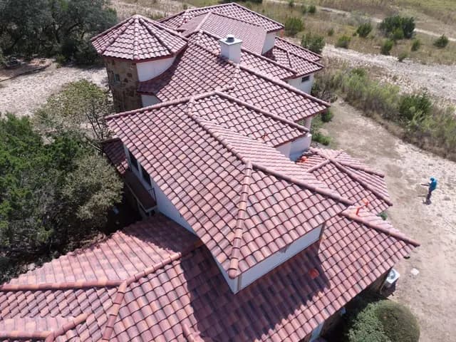 Concrete S-profile tile roof close-up showing hips, ridges, and field tile