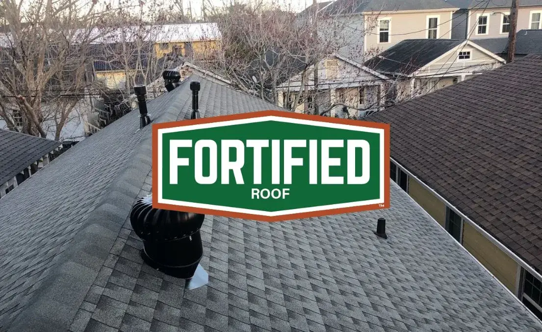 Professional roofing inspector examining shingles on a Gulf Coast home before hurricane season