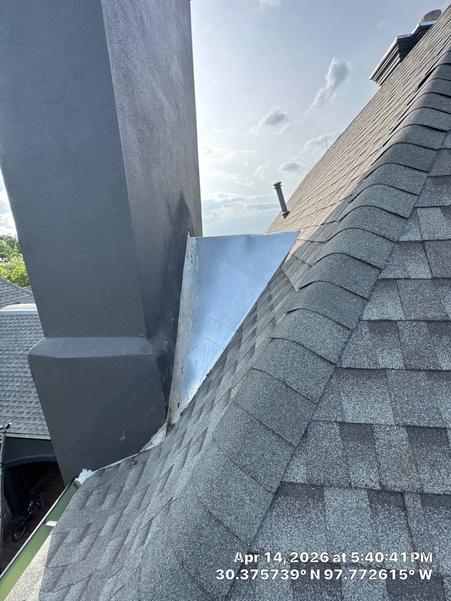 Chimney flashing and adjoining shingle roof slope at an Austin project