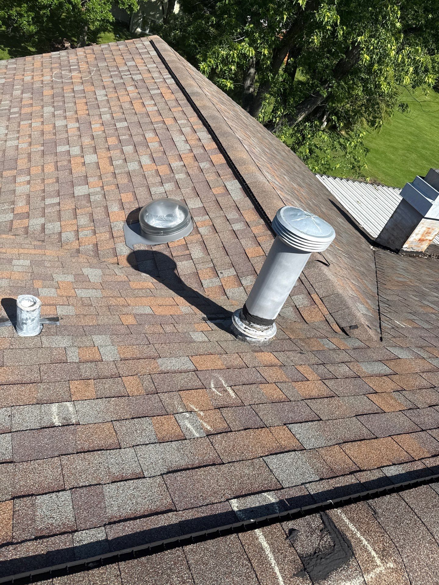 Existing ridge vent and roof penetrations documented at a Maryland Heights property
