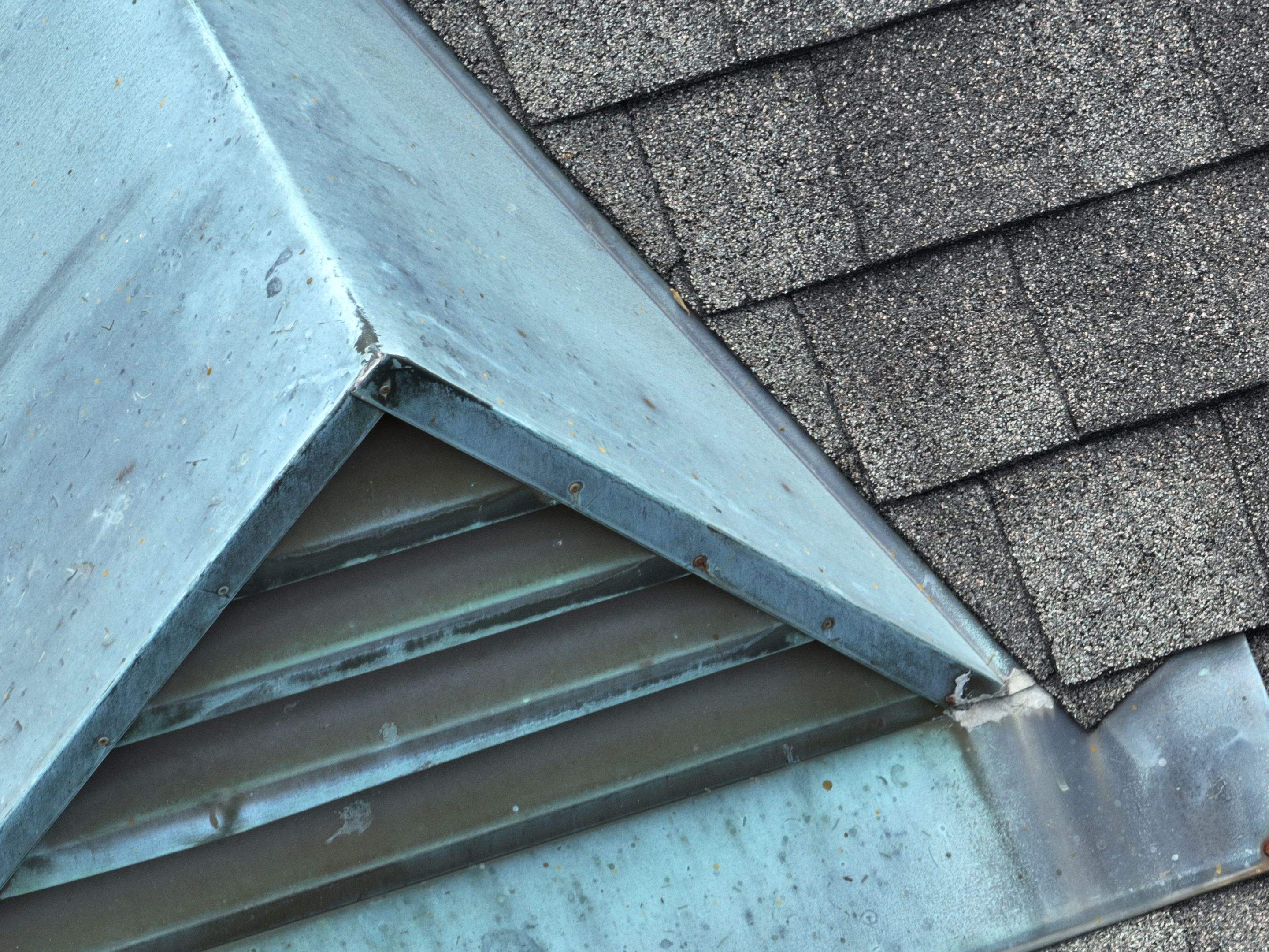 Existing louvered roof vent and surrounding shingles at an Audubon Street property in New Orleans