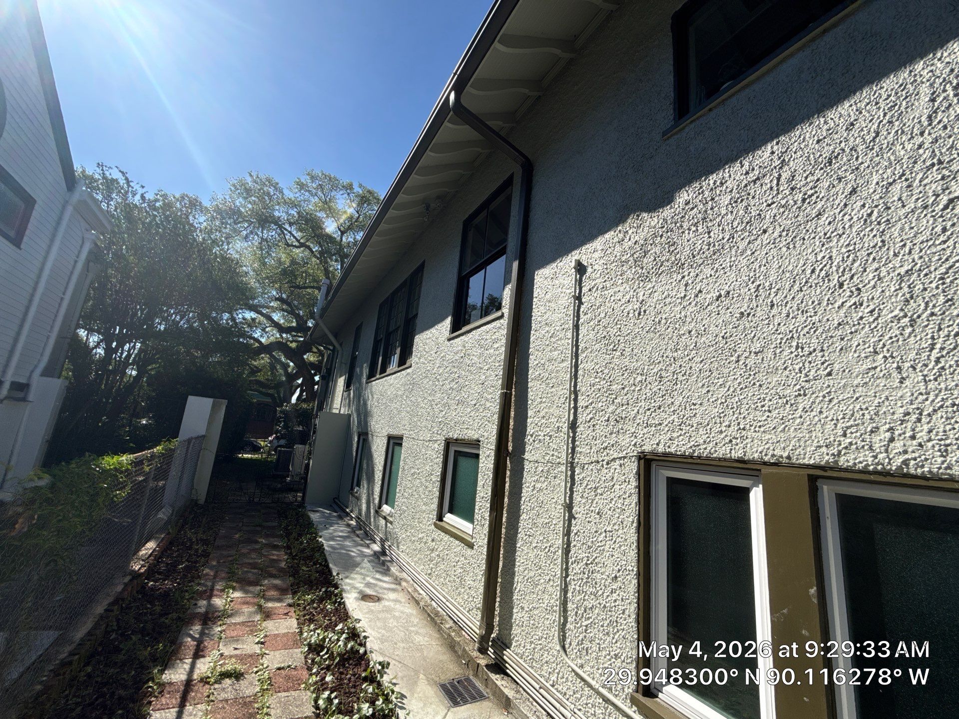 Narrow side passage between homes beside roof eaves on Audubon Boulevard in New Orleans